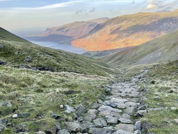 Scenic view wastwater from scafell pike with backdrop of mountains against sky