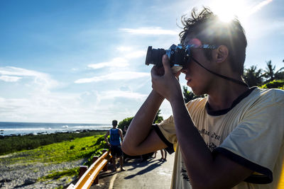 Man taking picture with a digital camera