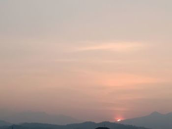 Scenic view of silhouette mountains against sky at sunset