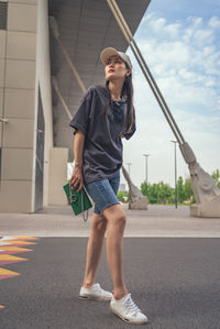Portrait of young woman walking on street