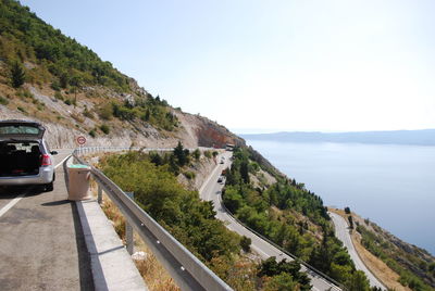 Road by sea against sky