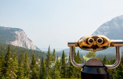 Low angle view of coin-operated binoculars against sky - banff fairmount springs