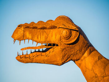 Low angle view of statue against clear blue sky