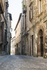 Narrow alley amidst buildings in city