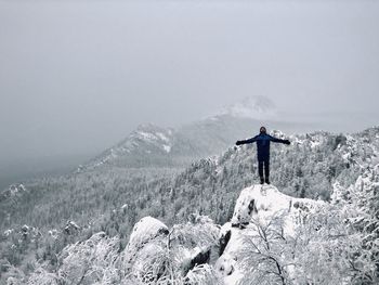 Man standing on snow covered mountain