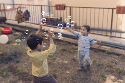 Full length of children playing in farm