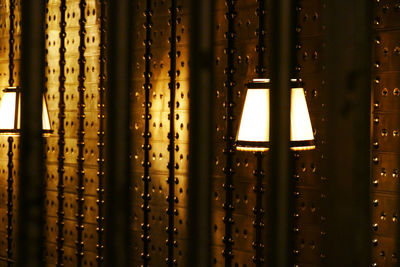 Illuminated lights seen through glass window at night