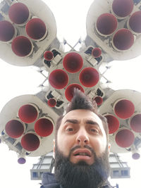 Low angle view of man looking away against ceiling