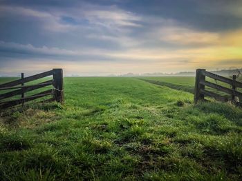 Fence on field against sky