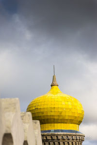 High section of a temple against cloudy sky