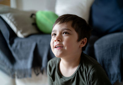 Portrait of boy sitting at home