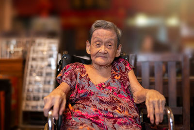 Close-up portrait of senior woman sitting at home