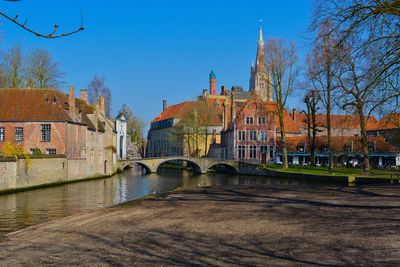 Brugge bridge over river against buildings in city