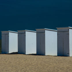 Structure on sand with sky in background