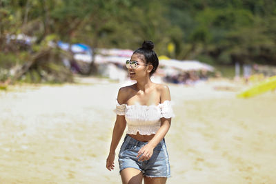 Young woman standing on beach