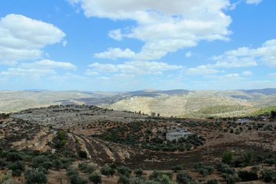 Aerial view of landscape against cloudy sky