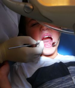 Dentist examining boy