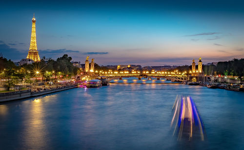 Illuminated buildings in city at waterfront