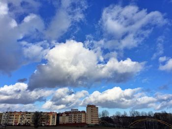 Buildings against cloudy sky