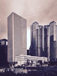 Low angle view of buildings against cloudy sky