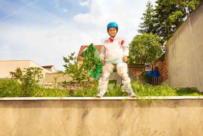 Low angle view of man standing on footpath