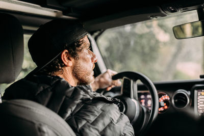 Portrait of man traveling in car