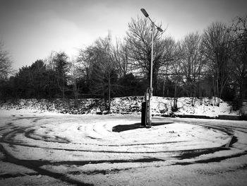 Bare trees on snow covered landscape