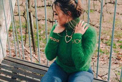 Midsection of woman sitting outdoors