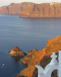 Rock formations by sea against sky