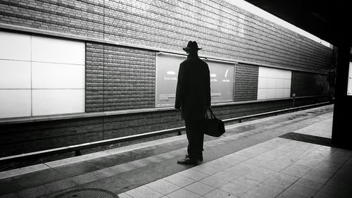 Full length of woman walking on tiled floor