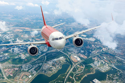 Plane flying sky. airplane above city. passenger aircraft climbs through the clouds. 