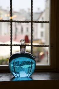 Close-up of electric lamp on window sill