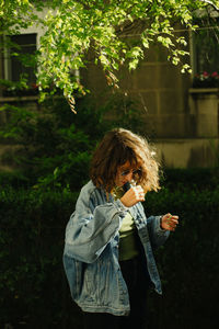 Young woman standing in garden