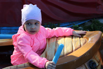 Portrait of cute girl sitting outdoors