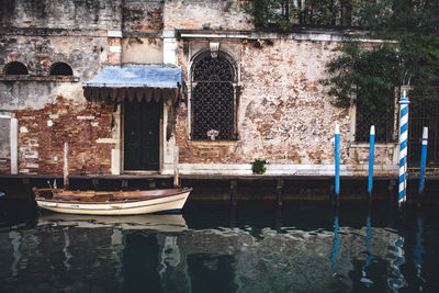 Boat on canal against old building