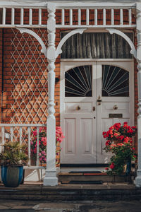 White stained glass front door of edwardian house in london, uk, sunlight hits brick wall. 