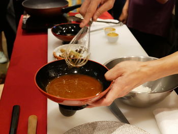 Midsection of man preparing food on table