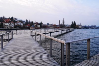 Pier on lake against sky