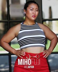 Portrait of a beautiful young woman standing outdoors