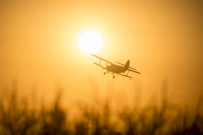 Silhouette of airplane at sunset