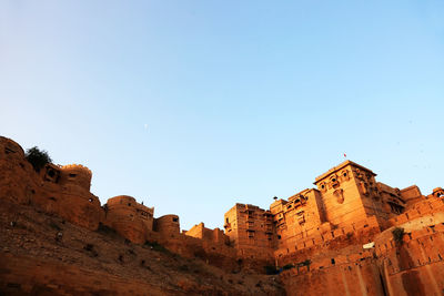 Low angle view of historic building against clear blue sky