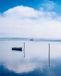 Sailboat in sea against sky