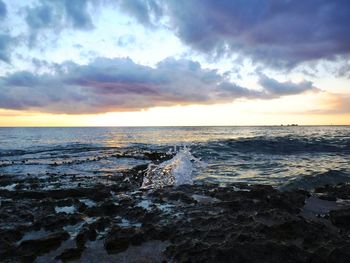 Scenic view of sea against cloudy sky