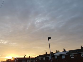 Low angle view of buildings against sky during sunset