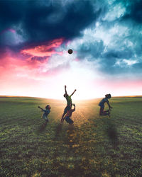 People playing with ball on field against sky during sunset