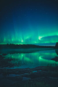 Scenic view of river against sky at night