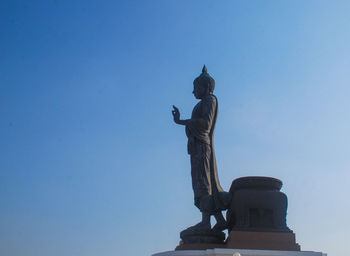 Low angle view of statue against blue sky