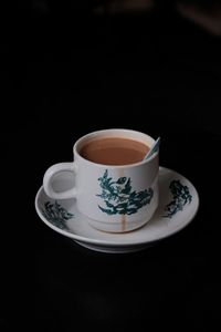 High angle view of coffee cup against black background