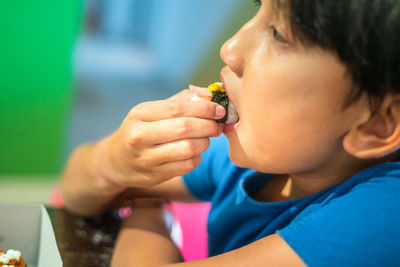 Cute boy eating food outdoors