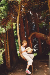 Man standing on tree trunk